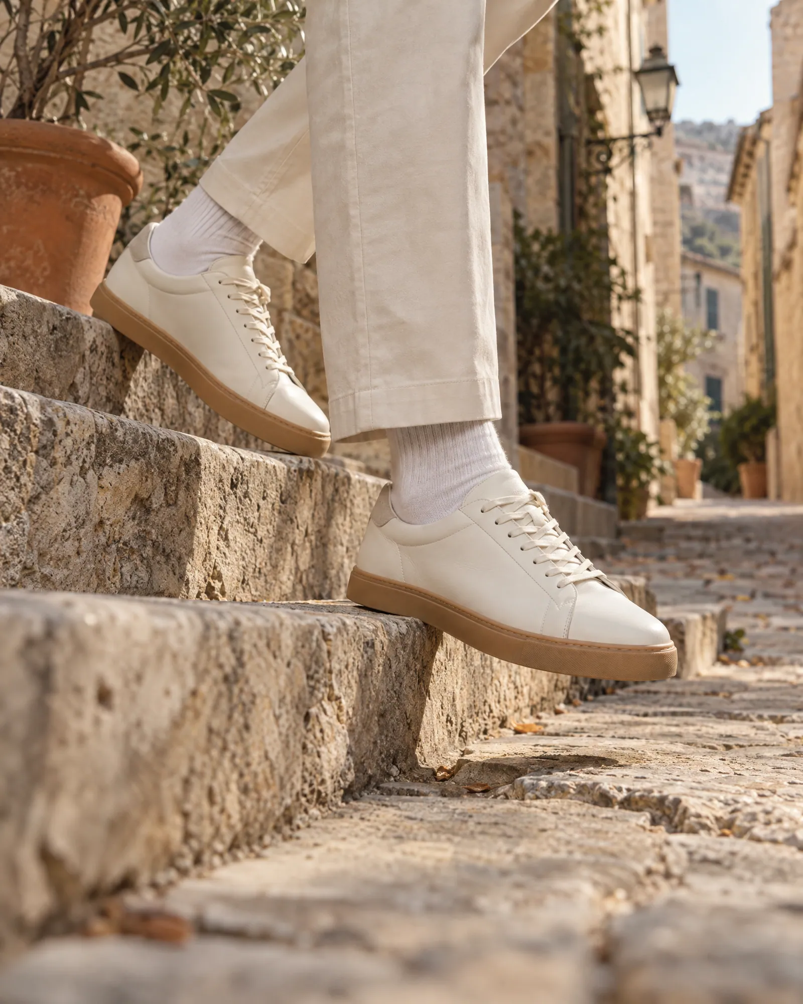 Sneakers on foot stepping down an old city stair (Helium-made example)