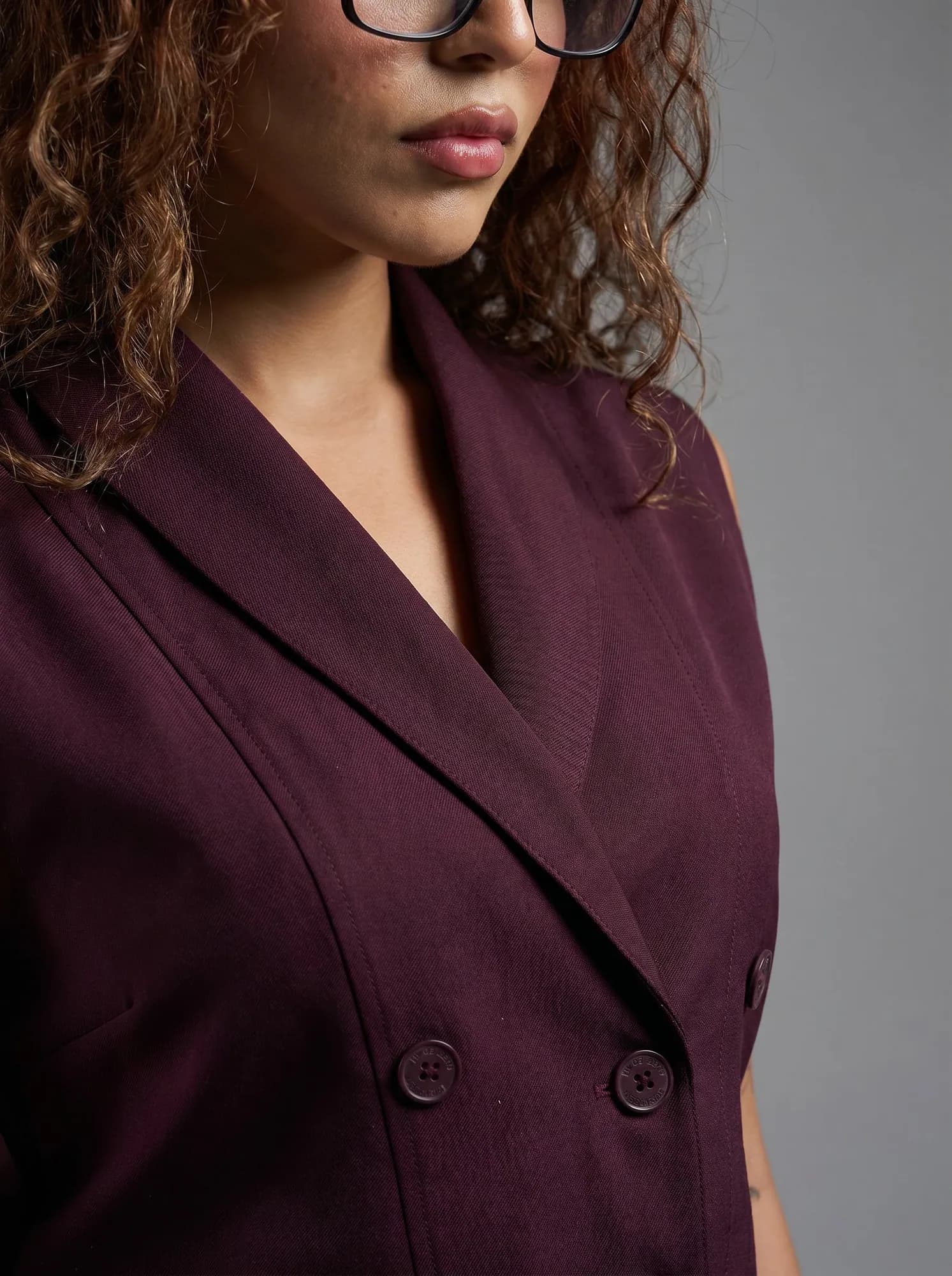 AI fabric close-up of a Bossbella plum blazer