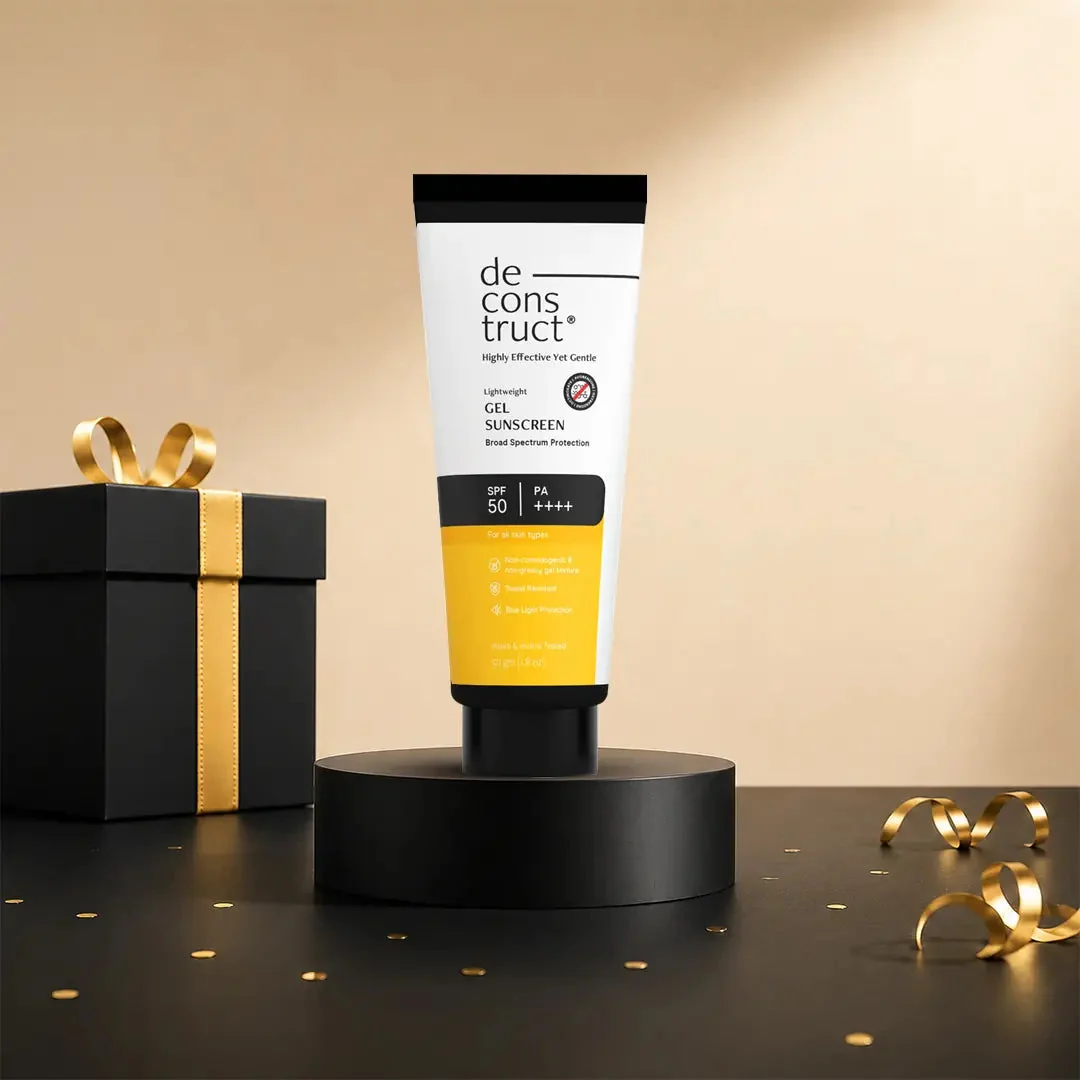 Deconstruct gel sunscreen on a black plinth with gold ribbon